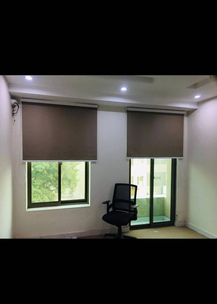 Roller blinds fitted on a window in an Islamabad home